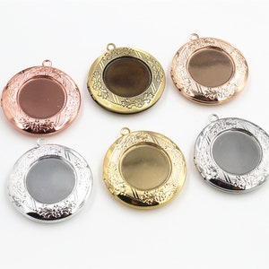 May include: Six round metal locket pendants with ornate floral designs. The lockets are in various finishes: gold, silver, bronze, and rose gold.