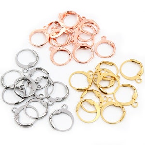 May include: A set of 30 earring hoops in three different colors: gold, silver, and rose gold. The hoops are made of metal and have a hinged closure.