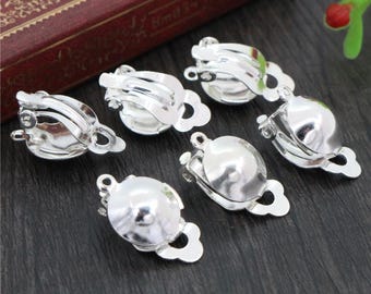 May include: Six silver-toned earring clips with a rounded, slightly domed shape. The clips are designed to be used with a variety of earrings.
