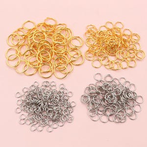 May include: A large quantity of gold and silver jump rings. The jump rings are small and circular, perfect for jewelry making.