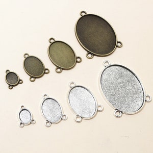 May include: Assortment of oval-shaped metal pendant trays in silver and bronze finishes. Each tray has three loops for attaching to jewelry making projects.