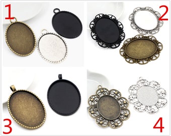 May include: Assortment of 4 different oval-shaped pendant trays with various decorative edges. The trays are made of metal and have a silver, black, or bronze finish. The trays are numbered 1 through 4.