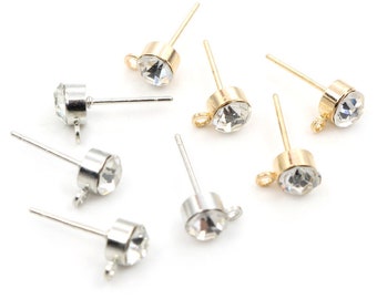 May include: A set of six earring findings with clear crystal stones and a loop for attaching charms. The findings are available in both silver and gold tones.