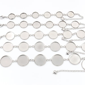 May include: Four silver bracelet blanks with round, flat, silver-toned metal circles connected by a silver chain. The bracelets are of different lengths, with the longest bracelet having 10 circles and the shortest bracelet having 4 circles.
