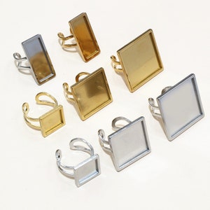 May include: Assortment of gold and silver ring blanks with square and rectangular shaped glass inserts. The ring blanks are made of metal and have a smooth finish.