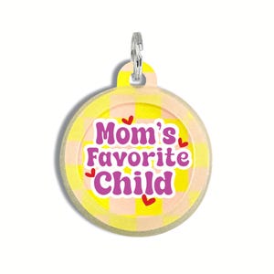 May include: Round yellow and pink checkered pet tag with the text "Mom's Favorite Child" in purple with red hearts.