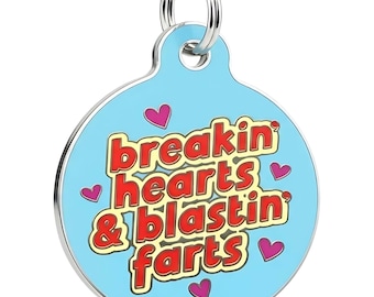 May include: A round, light blue pet tag with a silver-colored rim and a silver ring for attachment. The tag features the phrase "Breakin' hearts & blastin' farts" in red and yellow lettering, with pink heart accents.