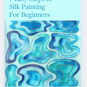 May include: A book cover titled "7 Easy Steps to Silk Painting For Beginners" by Lamaila Silks. The cover displays an abstract design in shades of blue and teal. The text "An easy-to-follow guide to help you learn the basics of silk painting in 7 easy steps. by Naomi Burnett" is also visible.