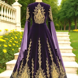 May include: A long, dark purple velvet gown with gold embroidery. The dress features intricate gold designs on the bodice, sleeves, and skirt. The sleeves are a lighter purple, and the hem is embellished with a dark, glittery fabric. The dress is worn outdoors.