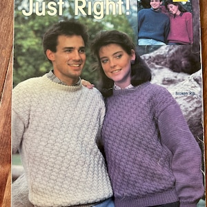 May include: A vintage knitting pattern leaflet titled "Just Right!" features a couple wearing textured knit sweaters. The cover includes the text "LEISURE ARTS" and "Designs by Arleen Wurman." A smaller image shows the sweaters in different colors.