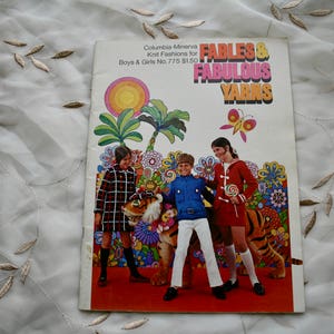 May include: A vintage knitting pattern book cover featuring a colourful illustration of children with a tiger and flowers. The title is "Fables & Fabulous Yarns" with the text "Columbia-Minerva Knit Fashions for Boys & Girls No. 775 £1.50".