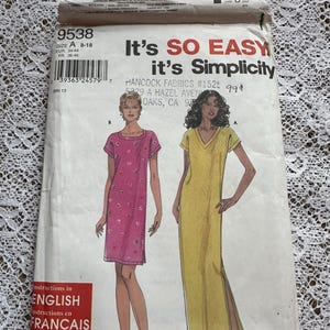 May include: A sewing pattern for two dresses. The pattern is for sizes 8-18. The dresses are both sleeveless and have a V-neck. The dress on the left is pink with a floral print. The dress on the right is yellow. The pattern is from Simplicity and is called "It's So Easy, It's Simplicity".