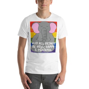 May include: White t-shirt with a rainbow background and a gray elephant meditating with the text "May all beings be well, happy & peaceful".