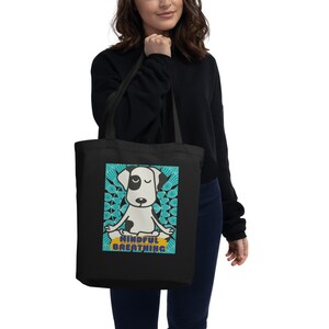 May include: Black tote bag with a white dog meditating with the text "Mindful Breathing" in a blue and yellow circle.