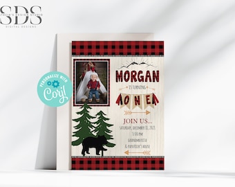 May include: A red and black plaid invitation with a photo of a child in a plaid shirt. The invitation says "Morgan is turning one" with a banner of flags that say "one". The invitation also includes a black bear and pine trees.