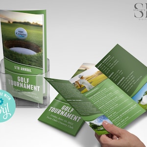 May include: Green and white golf tournament brochure with event details. The brochure includes the text "5th Annual Golf Tournament" and "Twin Oaks Country Club". The brochure is displayed in a clear plastic holder.