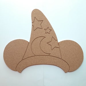 May include: A brown corkboard shaped like Mickey Mouse ears with a wizard hat on top. The hat has a crescent moon and stars cut out.