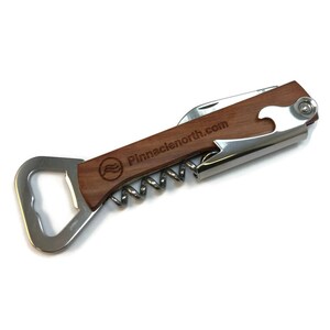 May include: A wooden handled bottle opener with a corkscrew and a bottle opener. The handle is engraved with the text "Pinnaclenorth.com".