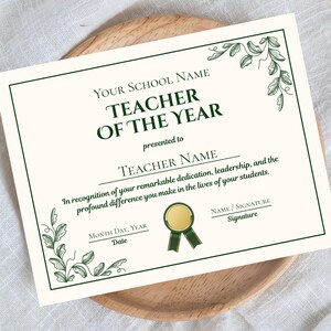 May include: A cream-colored certificate with green text and decorative leaf accents. The text reads "Teacher of the Year" and includes spaces for the school name, teacher's name, date, and signature. A gold seal with a green ribbon is also featured.
