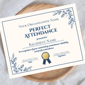 May include: A cream-colored certificate with navy blue text and decorative floral corner accents. The text reads "PERFECT ATTENDANCE" and includes spaces for the recipient's name, date, and signature. A gold seal with a blue ribbon is also featured.