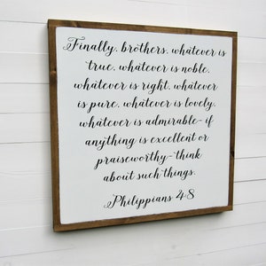 May include: White wooden sign with a brown frame. The sign features a black and white text quote from Philippians 4:8, "Finally, brothers, whatever is true, whatever is noble, whatever is right, whatever is pure, whatever is lovely, whatever is admirable - if anything is excellent or praiseworthy - think about such things."