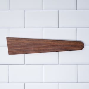 May include: A brown wooden spatula with a slightly curved handle and the text "BARLEYWOOD" engraved on the surface.