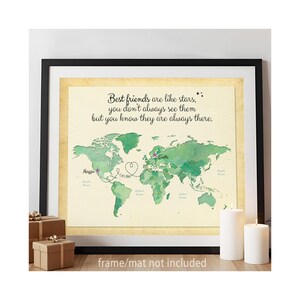 May include: A framed world map print with a watercolor effect in shades of green. The map features dotted lines connecting locations, with text that reads "Best friends are like stars, you don't always see them but you know they are always there."