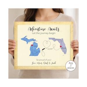 May include: A rectangular framed print featuring a map of Michigan and Florida connected by a dotted line with a car icon and a heart shape. Text reads: Adventure Awaits, Let the journey begin, Home, Mandy, 1,409 Miles, So proud of you!, Love, Mom, Dad & Jack.