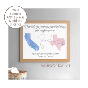 May include: A framed print featuring a blue watercolor map of California and a pink watercolor map of Texas. A heart-shaped line connects the two states with the text 1,457 Miles. Text reads: Your little girl yesterday, your friend today, your daughter forever. Miles apart, but always close at heart! Love you lots, Charlotte.