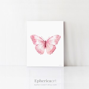 May include: A pink watercolor painting of a butterfly with detailed wing patterns. The artwork is displayed on a white background. The artist's name, "Ephericaart", and their Etsy shop URL are printed at the bottom.