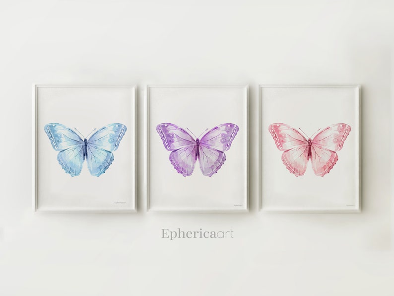 May include: Three framed watercolor butterfly prints. The butterflies are in shades of blue, purple, and pink. The artwork is displayed on a white background. The text "Ephericaart" is at the bottom of the image.