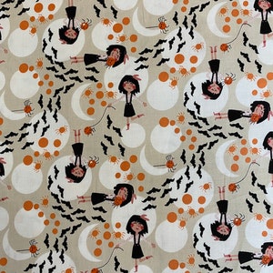 May include: A beige fabric with a repeating pattern of black bats, orange circles, white moons, and black silhouettes of girls holding spiders. The girls are wearing black dresses and white bows in their hair.