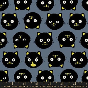 May include: A repeating pattern of black cat faces with yellow accents on a gray background. The cats have white eyes and yellow ears and mouths. The text "RUBY STAR SOCIETY" is at the bottom.