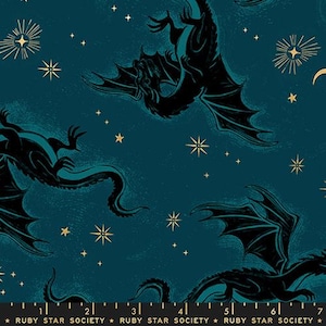 May include: Dark teal fabric with a repeating pattern of black dragons, stars, and celestial accents. Gold starbursts and crescent moons are scattered across the background. The text "RUBY STAR SOCIETY" is printed at the bottom.