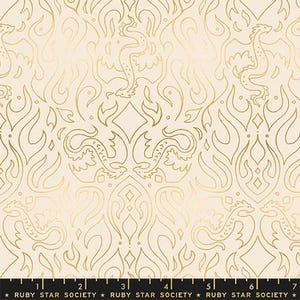 May include: Cream-colored fabric with a repeating gold pattern featuring stylized dragons and flame-like shapes. The design includes diamond and floral elements, creating a decorative and ornate look. The bottom edge has a ruler with the text "RUBY STAR SOCIETY".