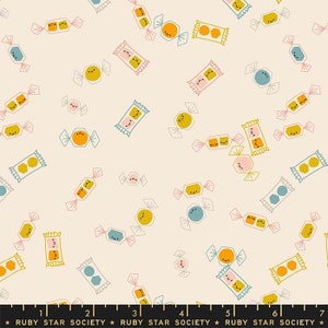 May include: A cream-colored fabric with a repeating pattern of cartoon candies. The candies are in various shapes and colors, including yellow, orange, blue, and pink, with smiling faces. The text "RUBY STAR SOCIETY" is at the bottom.