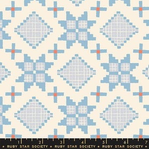 May include: A seamless pattern featuring a repeating design of blue and white geometric shapes on a cream background. The pattern is reminiscent of a traditional quilt or woven fabric.