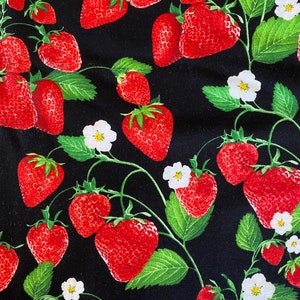 May include: A black fabric with a repeating pattern of red strawberries and white flowers. The strawberries are arranged in a random pattern and are surrounded by green leaves.