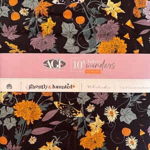 May include: A stack of 42 pieces of 10-inch fabric squares from Art Gallery Fabrics. The fabric features a black background with a pattern of orange pumpkins, yellow flowers, purple chrysanthemums, moths, and candy corn. The band reads Ghostly & Haunted.