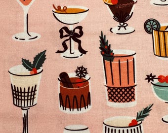 May include: A light pink fabric featuring a repeating pattern of various cocktail glasses. The illustrations include martini glasses with olives, coupes with bows, and tumblers garnished with holly, cinnamon sticks, and citrus slices.