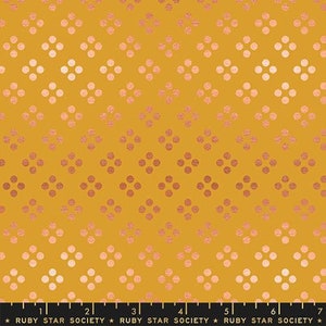 May include: Mustard yellow fabric with a repeating pattern of four-dot clusters in a gradient of rose gold. The fabric has a metallic sheen. The bottom of the image has a ruler and the text "RUBY STAR SOCIETY".