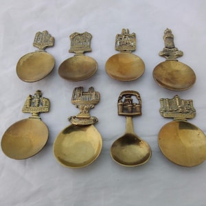 Collection of 8 Antique brass Tea Caddy Spoons featuring English landmarks