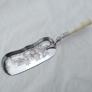 Beautiful antique silver plated crumb scoop with chunky carved handle