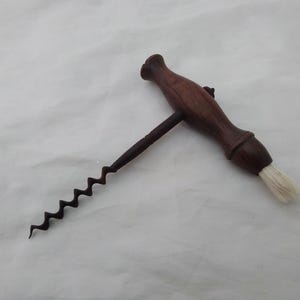 Quality antique corkscrew with wooden handle & brush