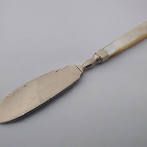 Early Antique silver plated butter spreader with carved mother of pearl handle