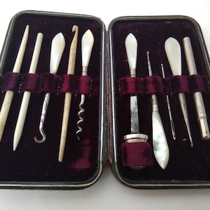 Cased antique mother of pearl manicure vanity set with thimble, perfume bottle corkscrew, button hook etc