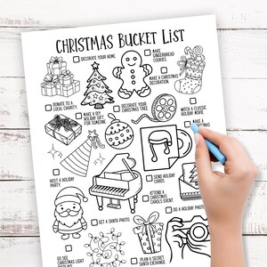 May include: A black and white Christmas bucket list with festive illustrations, including a Christmas tree, gingerbread man, and gifts. A hand with a blue pen is marking a box on the list. The text "CHRISTMAS BUCKET LIST" is at the top.
