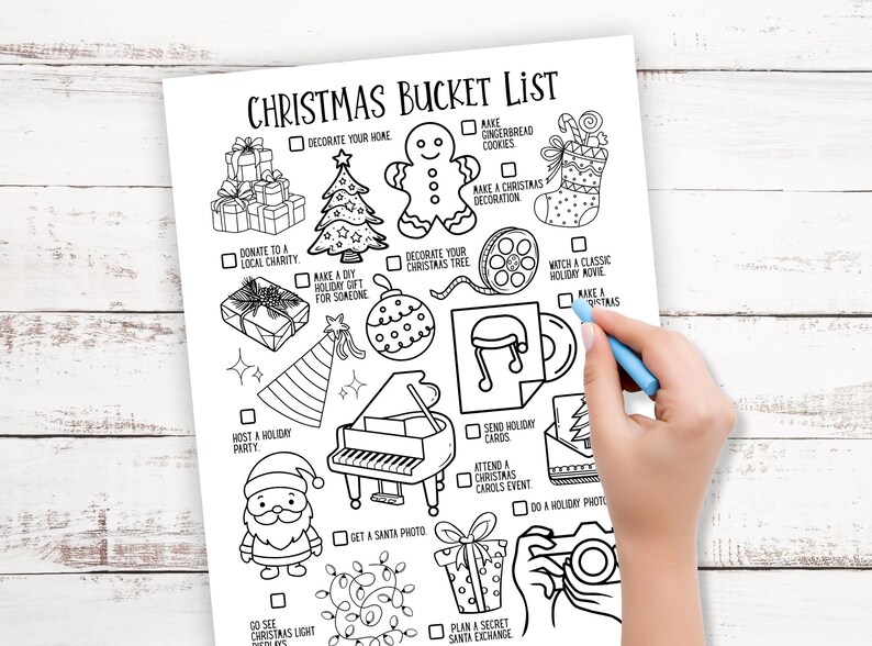May include: A black and white Christmas bucket list with festive illustrations, including a Christmas tree, gingerbread man, and gifts. A hand with a blue pen is marking a box on the list. The text "CHRISTMAS BUCKET LIST" is at the top.