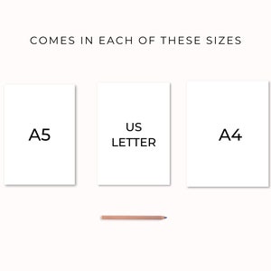 May include: Three white paper sheets with the text "A5", "US Letter", and "A4" printed on them. The sheets are arranged in a row from left to right. A pencil is lying below the sheets.