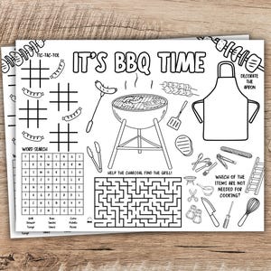 May include: Black and white BBQ-themed activity placemat with the text "IT'S BBQ TIME". Includes tic-tac-toe, word search, maze, and apron design. Features illustrations of grilling tools and food.